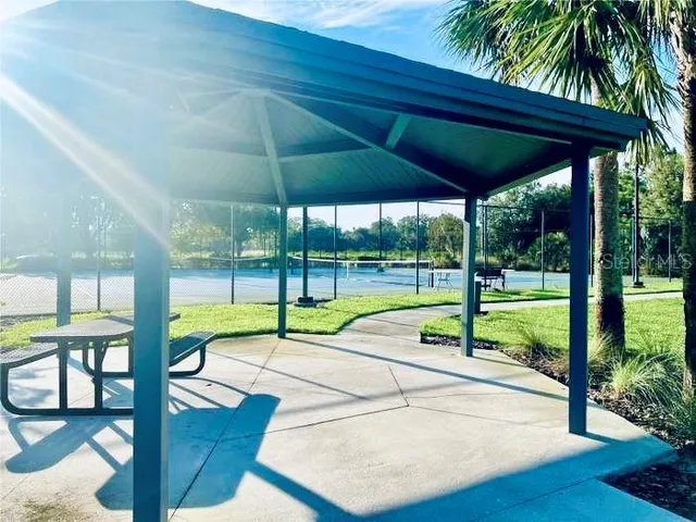 a view of a house with a yard and table under an umbrella