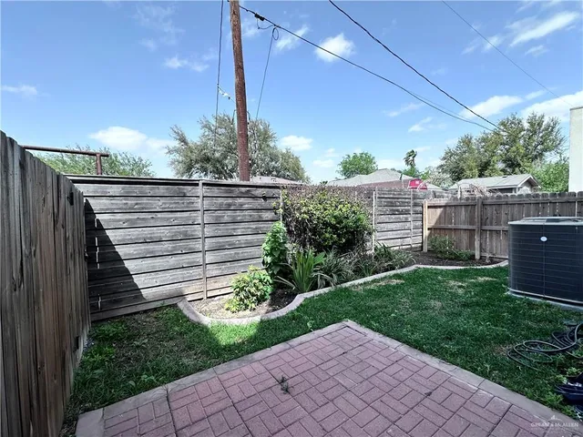 a view of a backyard with plants and a patio