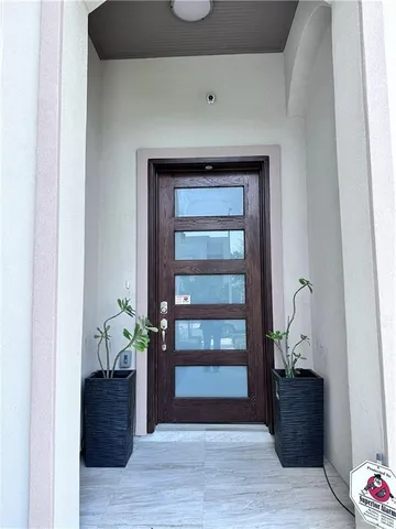 a room with a potted plant and wooden floor
