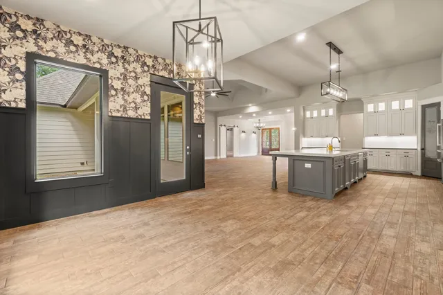 a view of a kitchen with a sink and a chandelier