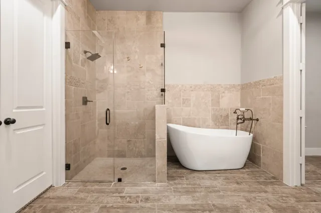 a bathroom with a bathtub and shower