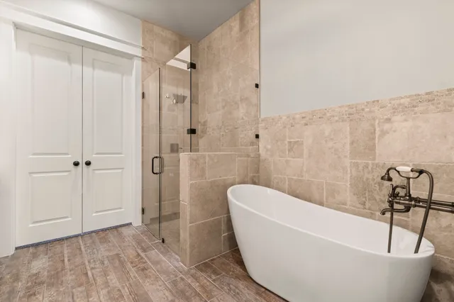 a bathroom with a bathtub and shower