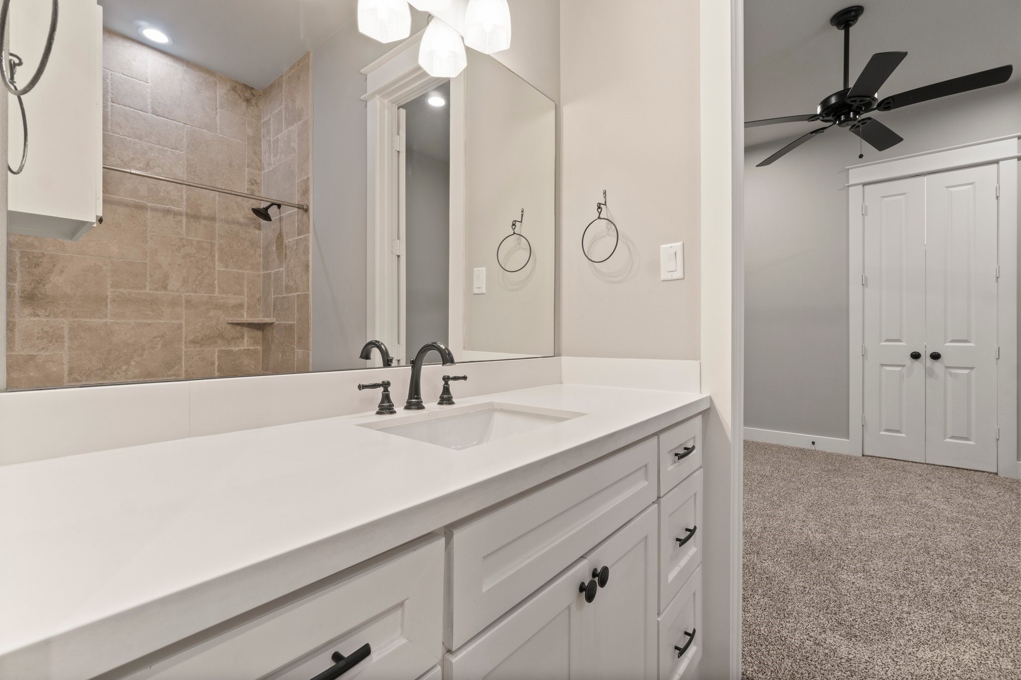 2402 Chantilly Lane Conroe, TX 77384 - Photo 30 of 49 a bathroom with a sink a vanity and a mirror