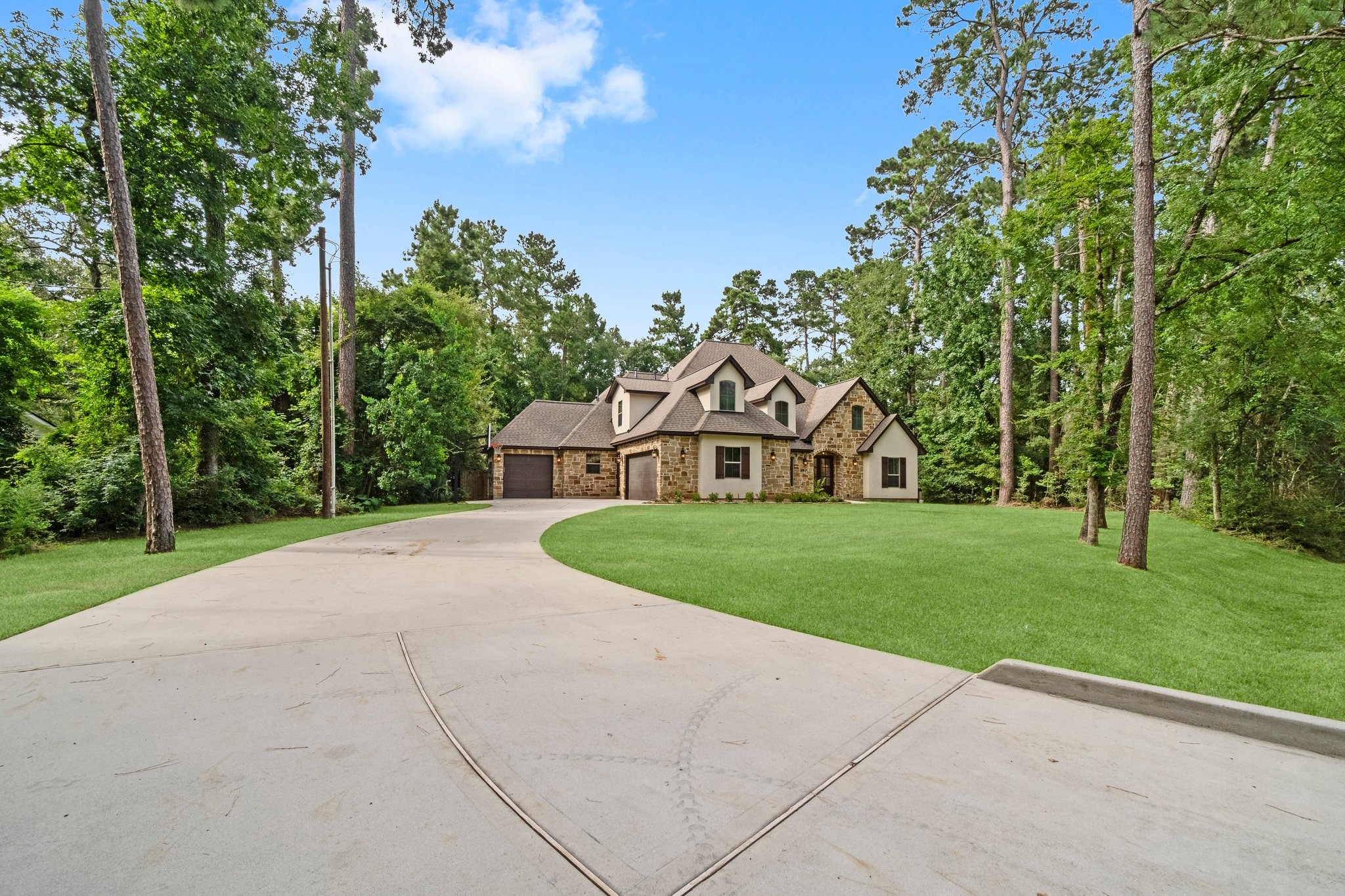 2402 Chantilly Lane Conroe, TX 77384 - Photo 3 of 49 a view of a house with a yard