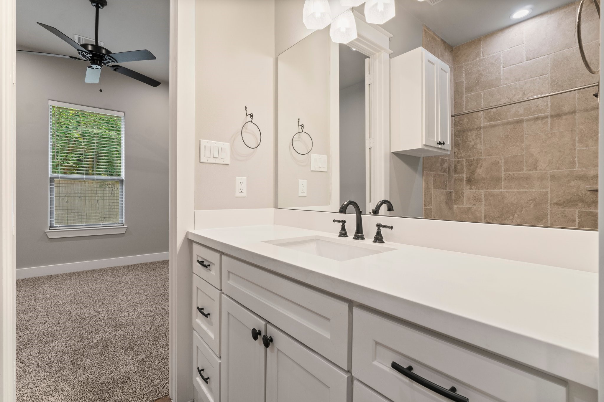 2402 Chantilly Lane Conroe, TX 77384 - Photo 31 of 49 a bathroom with a sink and a mirror