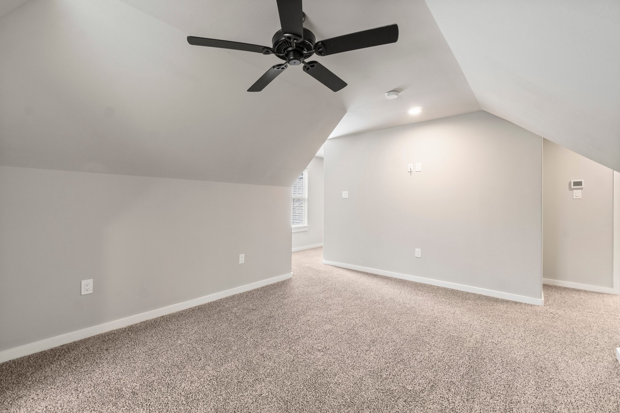 2402 Chantilly Lane Conroe, TX 77384 - Photo 39 of 49 an empty room with a ceiling fan and window