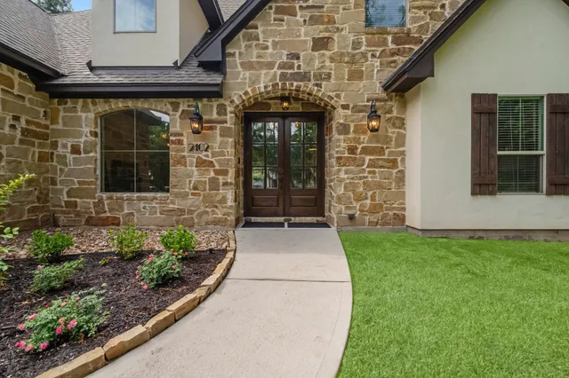 a front view of a house with garden