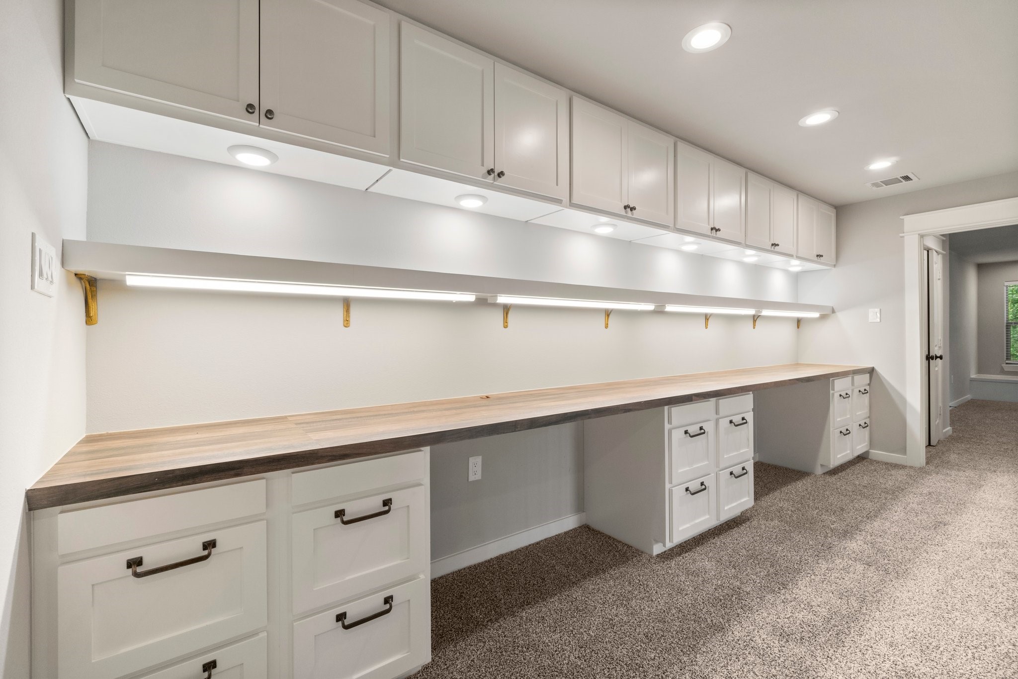2402 Chantilly Lane Conroe, TX 77384 - Photo 43 of 49 a kitchen with white cabinets and white appliances