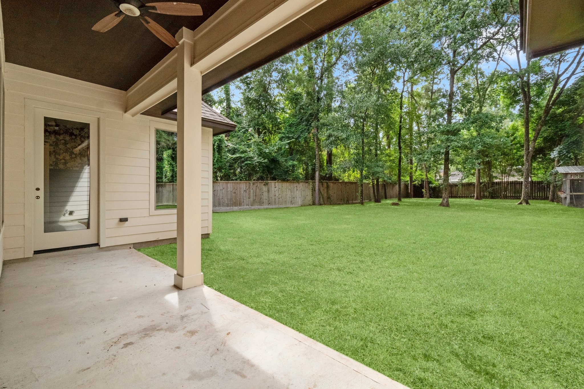 2402 Chantilly Lane Conroe, TX 77384 - Photo 46 of 49 a view of a backyard with a garden and trees