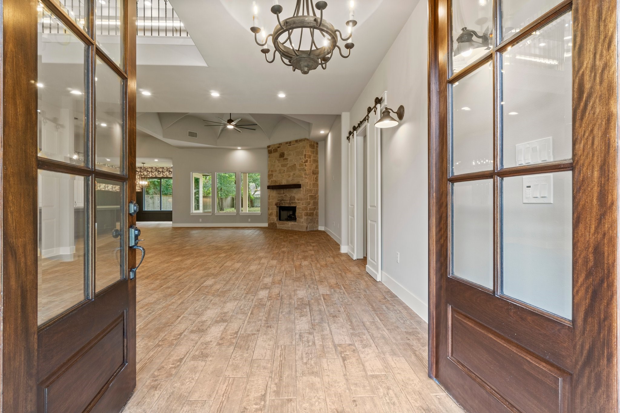 2402 Chantilly Lane Conroe, TX 77384 - Photo 5 of 49 a view of a hallway with a dining table stainless steel appliances