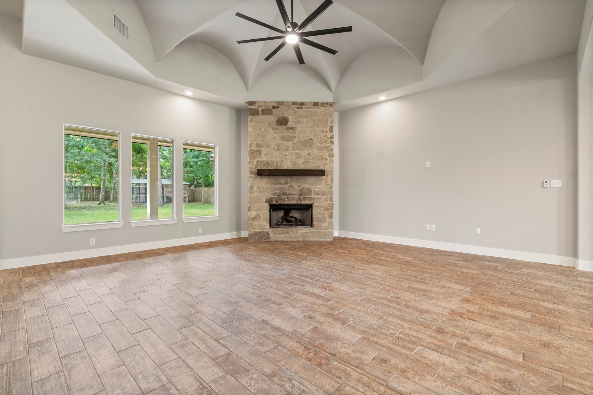 2402 Chantilly Lane Conroe, TX 77384 - Photo 7 of 49 a view of an empty room with a fireplace and a window