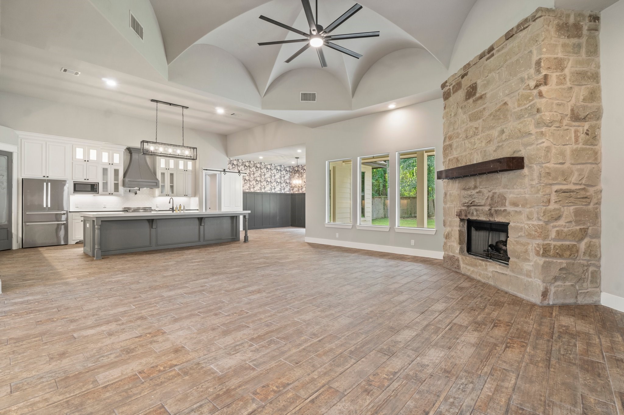 2402 Chantilly Lane Conroe, TX 77384 - Photo 8 of 49 a view of a livingroom with a fireplace and chandelier fan