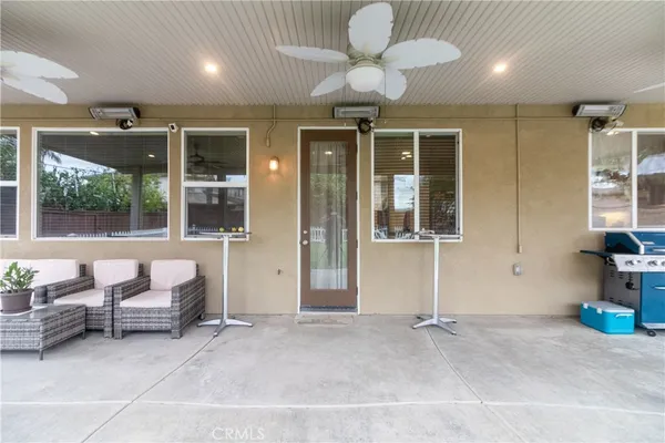 a view of a house with a backyard porch and sitting area