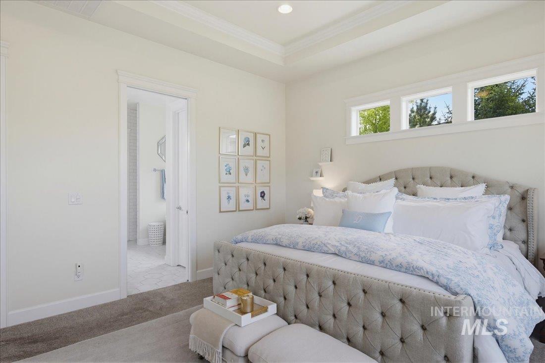 939 South Lake Pointe Way Eagle, ID 83616 - Photo 17 of 50 Bedroom featuring a tray ceiling, recessed lighting, and high transom windows