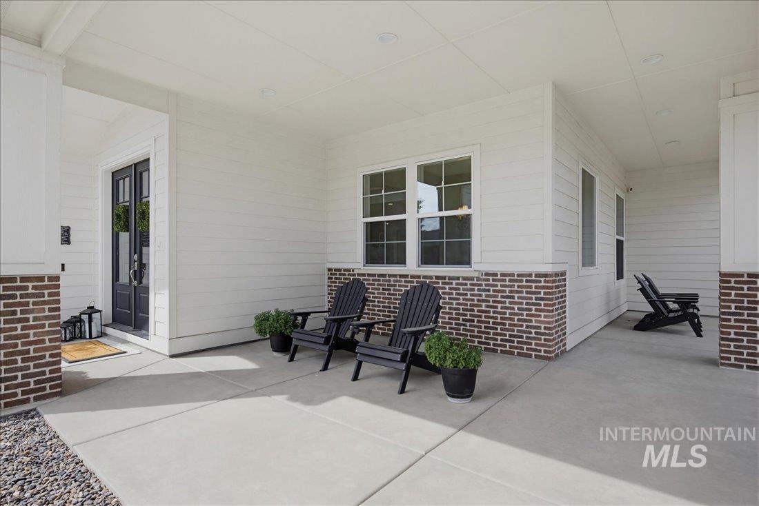 939 South Lake Pointe Way Eagle, ID 83616 - Photo 2 of 50 Covered front porch featuring white siding and brick accents