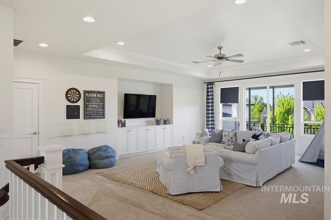 939 South Lake Pointe Way Eagle, ID 83616 - Photo 24 of 50 Spacious upper-level room featuring large sliding glass doors, built-in cabinetry, recessed lighting, and a ceiling fan