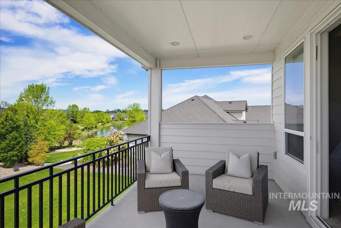 939 South Lake Pointe Way Eagle, ID 83616 - Photo 25 of 50 Covered balcony featuring a black metal railing, recessed lighting, and sliding glass door