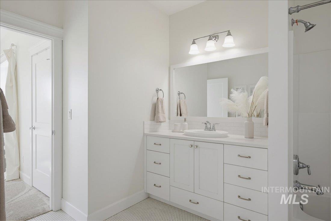 939 South Lake Pointe Way Eagle, ID 83616 - Photo 27 of 50 White vanity with dual cabinets and multiple drawers, featuring a light-colored countertop and a rectangular undermount sink