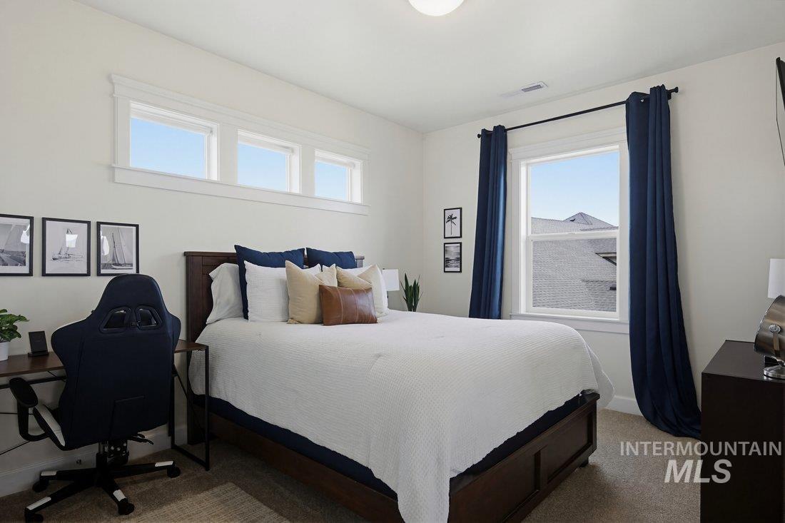 939 South Lake Pointe Way Eagle, ID 83616 - Photo 30 of 50 Bright bedroom featuring white walls and neutral-toned carpet