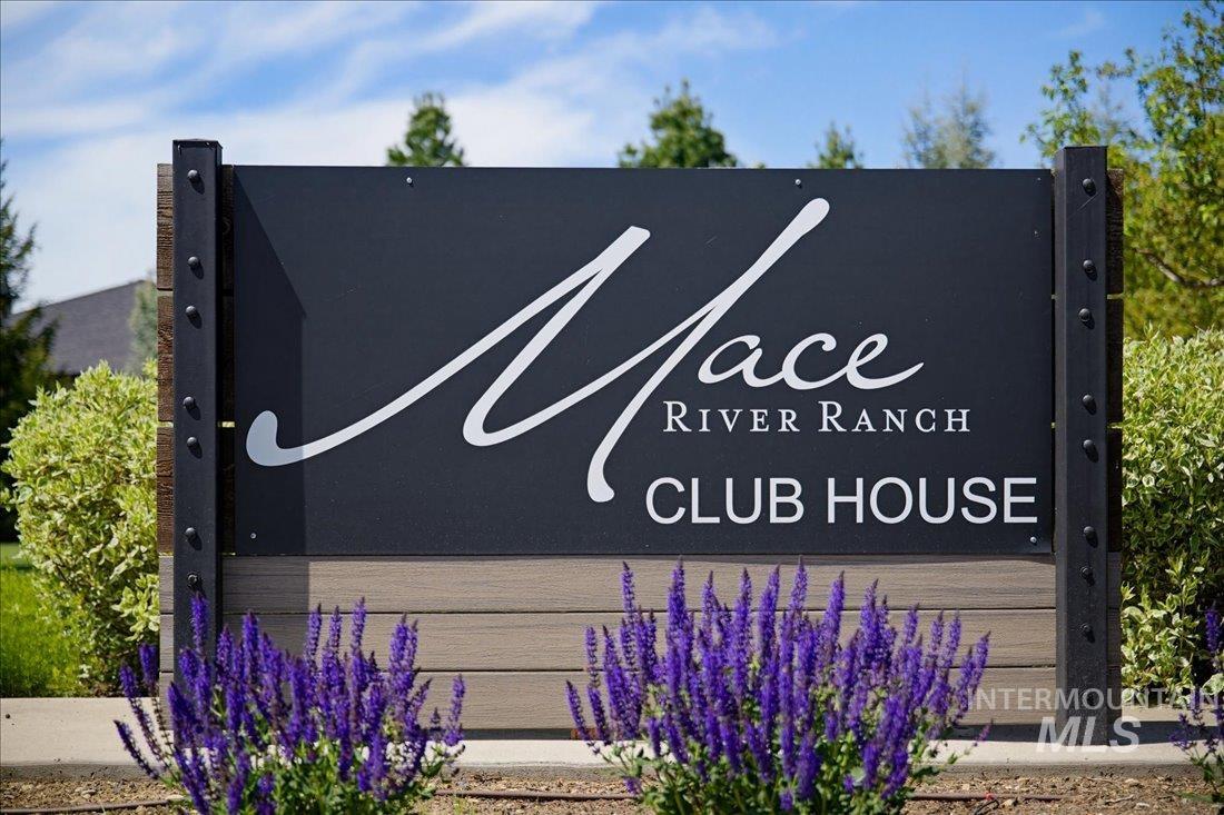 939 South Lake Pointe Way Eagle, ID 83616 - Photo 36 of 50 Mace River Ranch Club House entrance sign featuring a dark panel with white lettering, accented by faux wood paneling and dark metal posts with visible bolts