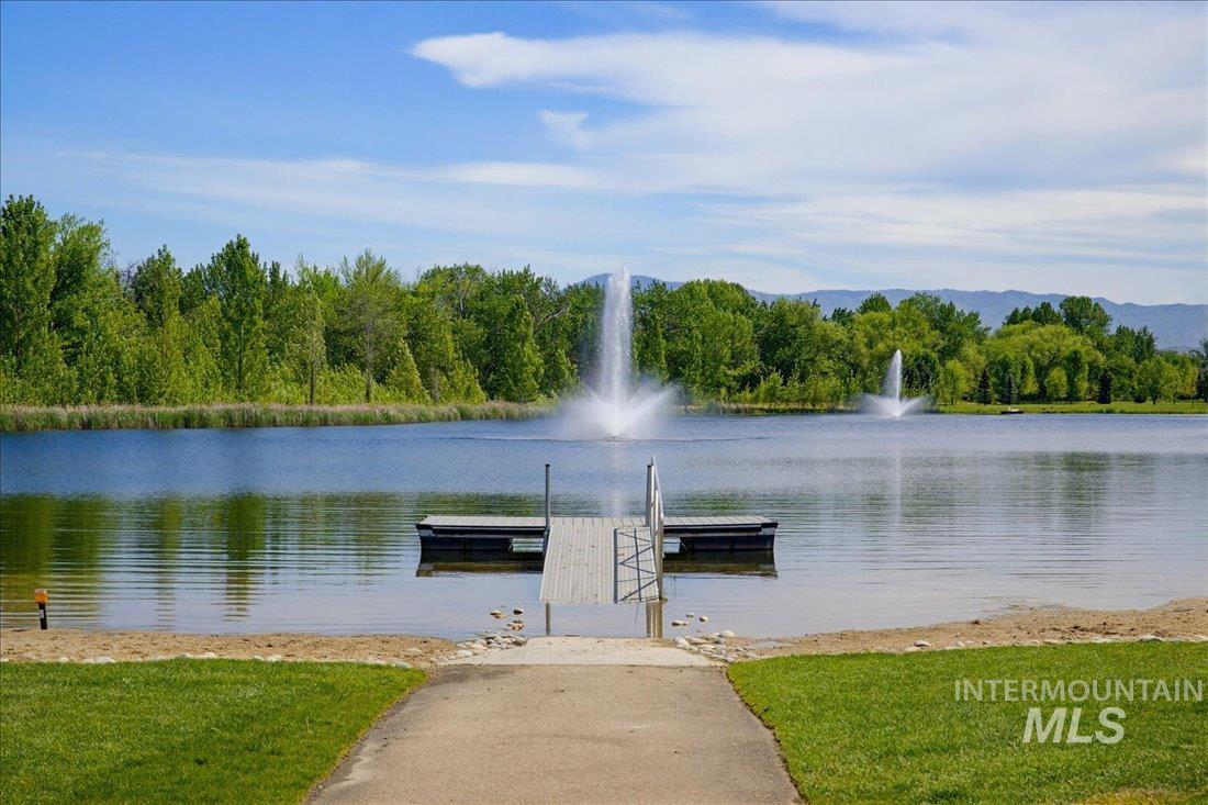 939 South Lake Pointe Way Eagle, ID 83616 - Photo 43 of 50 Waterfront access featuring a private dock, sandy beach area, and manicured lawn