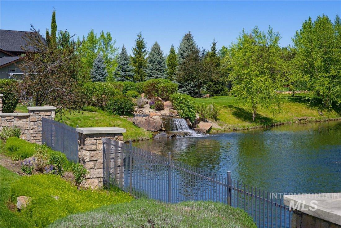 939 South Lake Pointe Way Eagle, ID 83616 - Photo 46 of 50 Water feature with a waterfall and pond surrounded by lush landscaping