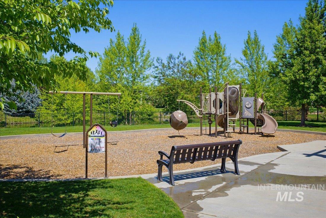 939 South Lake Pointe Way Eagle, ID 83616 - Photo 47 of 50 Outdoor playground featuring a swing set, multi-level play structure with slides, and a metal bench