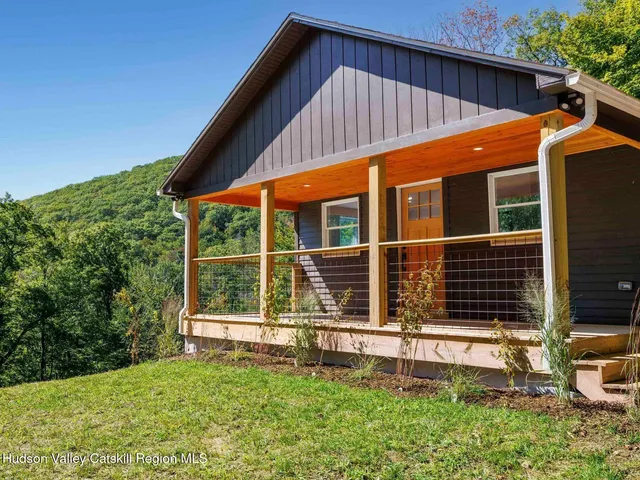 an aerial view of residential house with outdoor space and trees