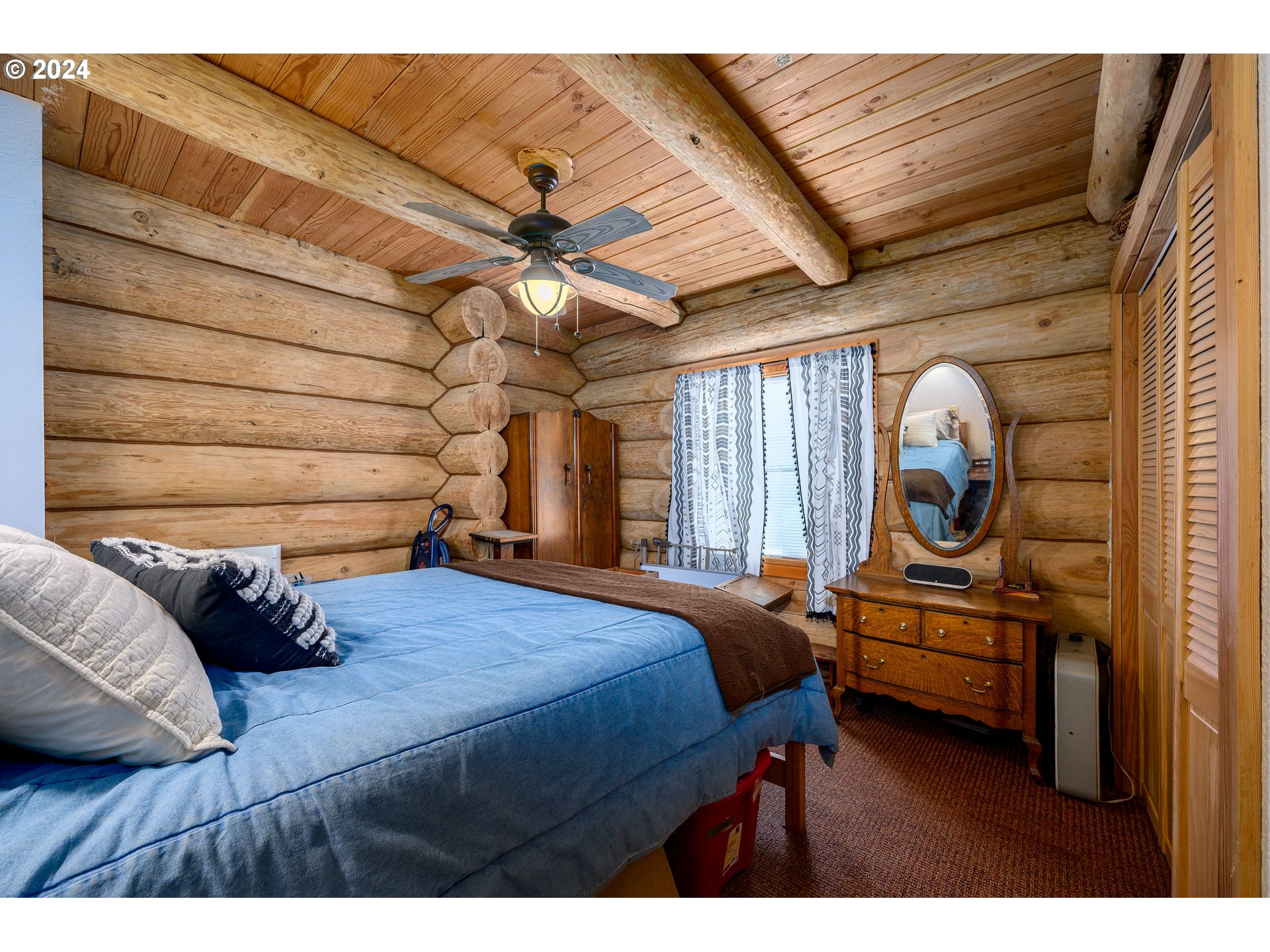 16300 Southeast Walnut Hill Road Amity, OR 97101 - Photo 14 of 48 a bedroom with a bed and a chandelier