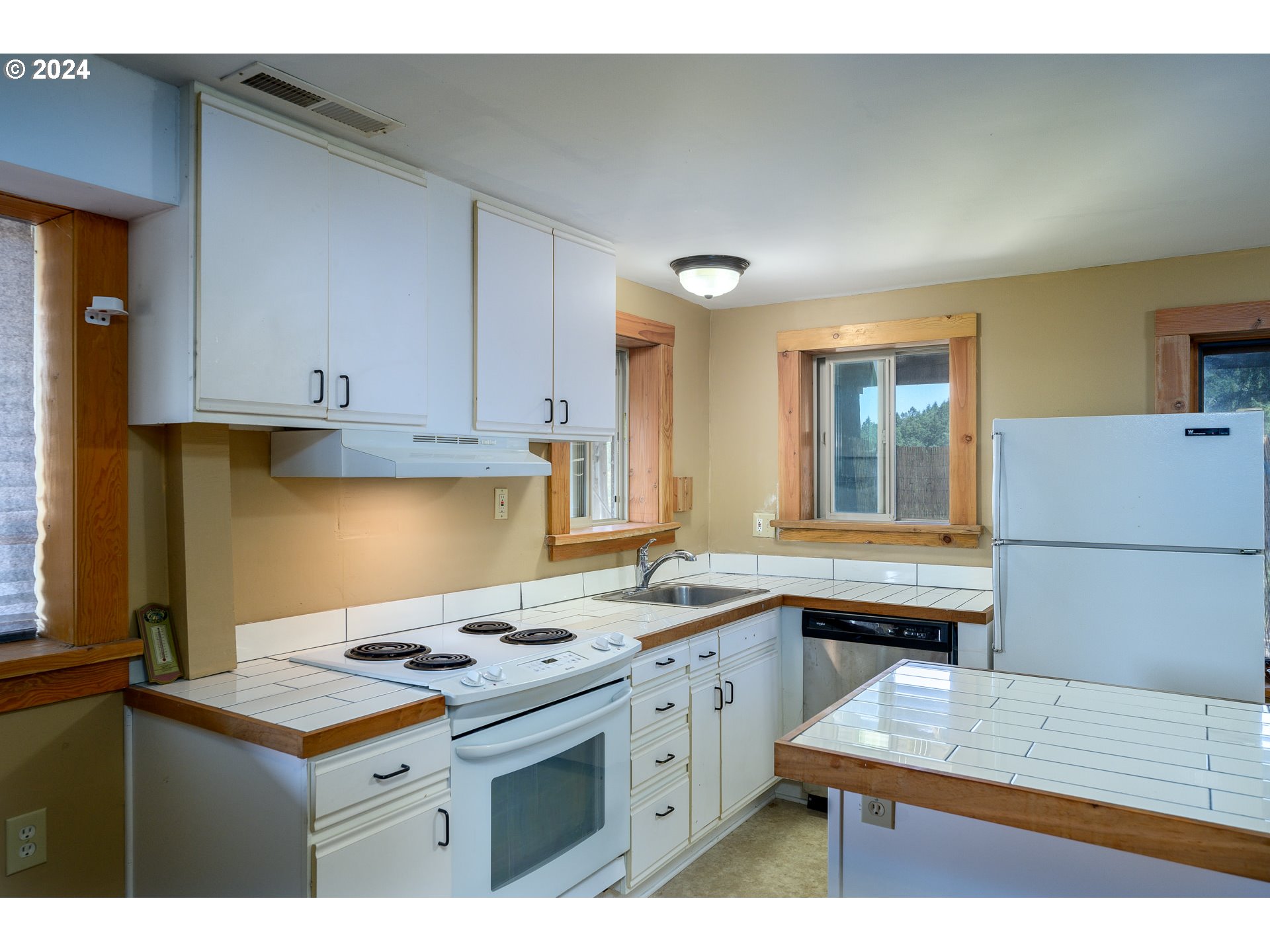 16300 Southeast Walnut Hill Road Amity, OR 97101 - Photo 28 of 48 a kitchen that has a sink a stove and a table in it