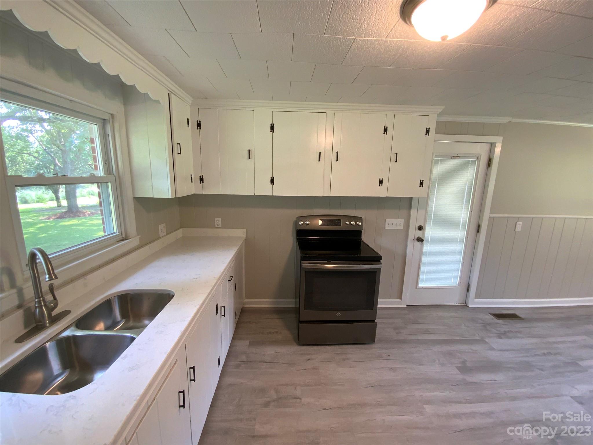 214 Bostic Yard Road Bostic, NC 28018 - Photo 8 of 31 a kitchen with granite countertop a sink and a stove top oven