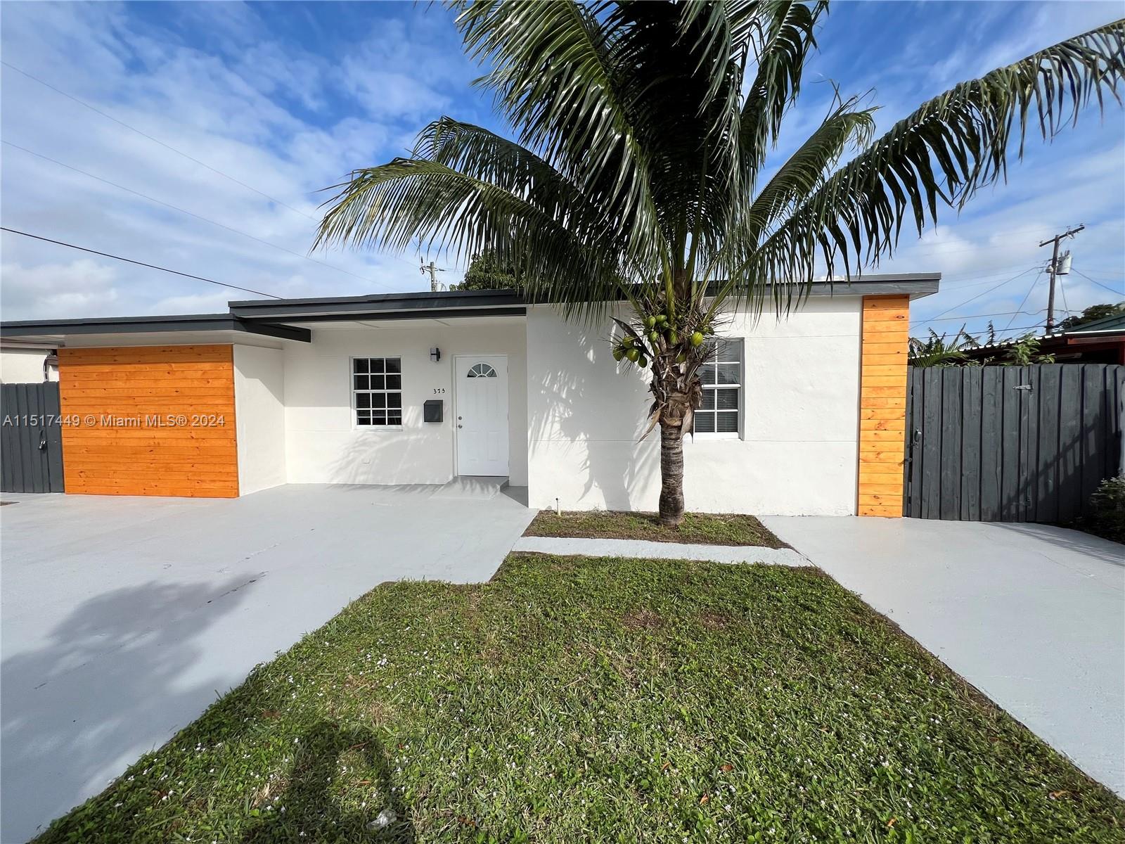 375 West 37th Street Hialeah, FL 33012 - Photo 1 of 19 a front view of a house with a yard