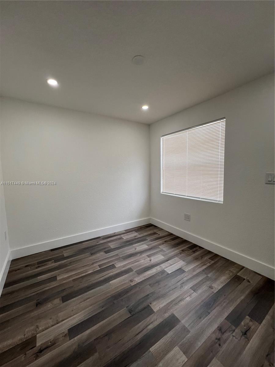 375 West 37th Street Hialeah, FL 33012 - Photo 13 of 19 a view of an empty room with wooden floor and a window