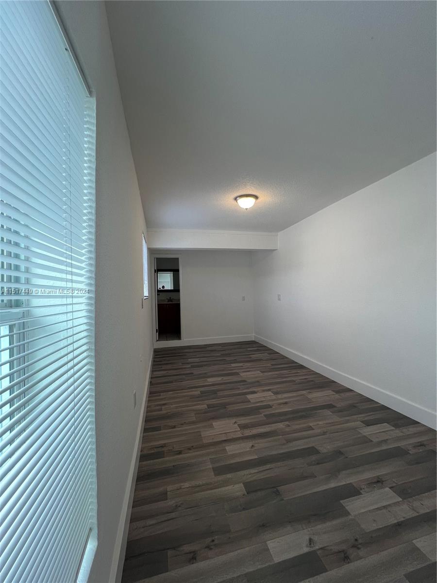 375 West 37th Street Hialeah, FL 33012 - Photo 17 of 19 a view of a hallway with wooden floor