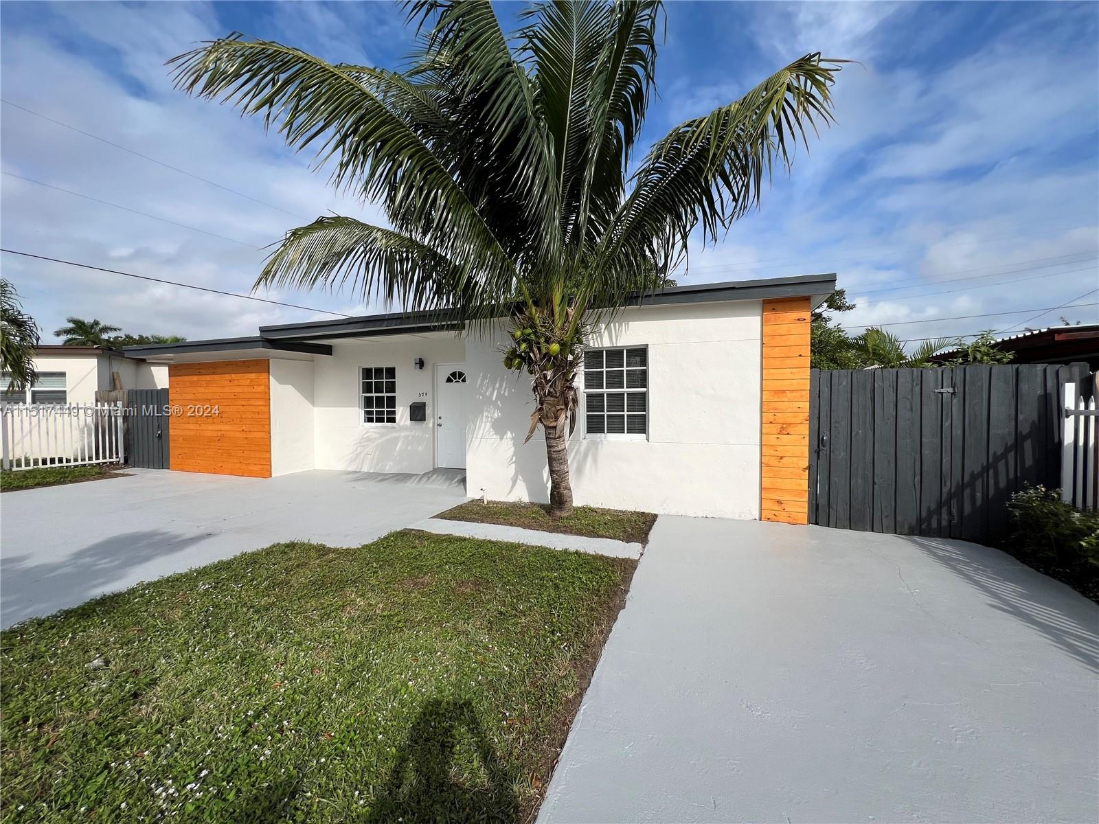 375 West 37th Street Hialeah, FL 33012 - Photo 2 of 19 a front view of house with yard and trees