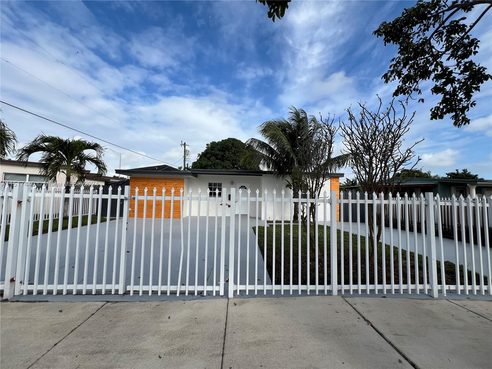 375 West 37th Street Hialeah, FL 33012 - Photo 3 of 19 a view of a brick house with wooden fence