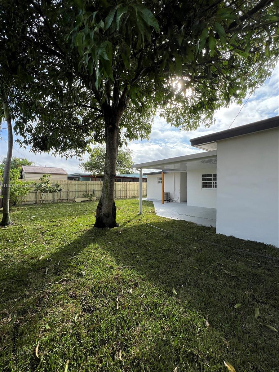 375 West 37th Street Hialeah, FL 33012 - Photo 5 of 19 a view of a house with yard and a tree