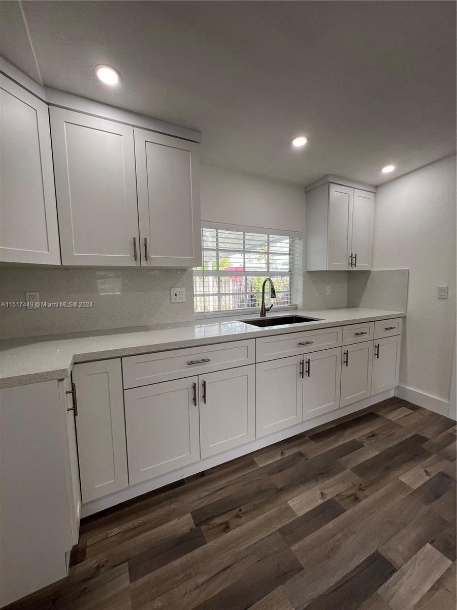 375 West 37th Street Hialeah, FL 33012 - Photo 8 of 19 a kitchen with granite countertop white cabinets and white appliances