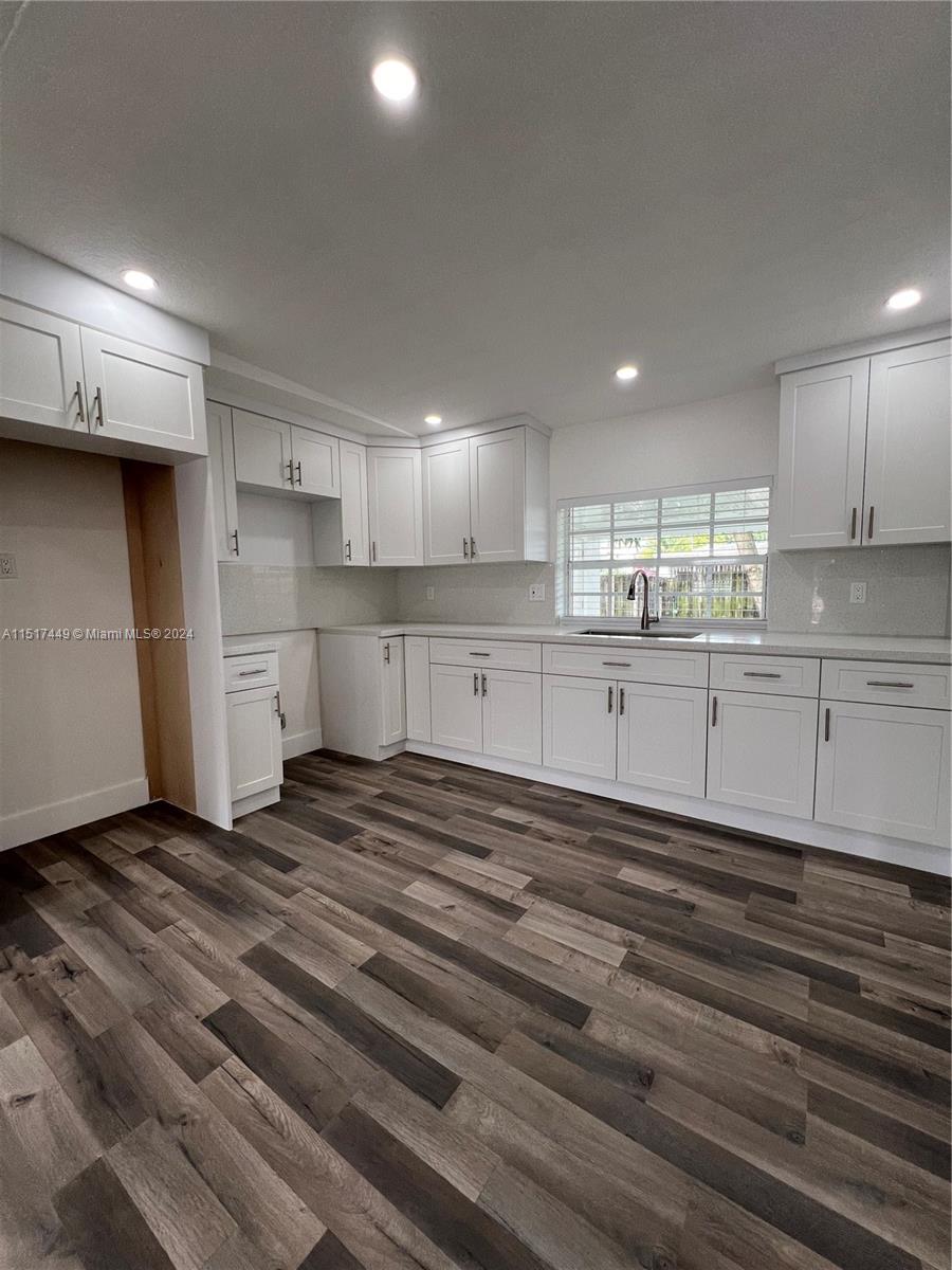 375 West 37th Street Hialeah, FL 33012 - Photo 9 of 19 a large kitchen with cabinets and wooden floor