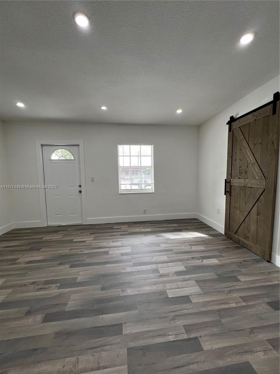 375 West 37th Street Hialeah, FL 33012 - Photo 10 of 19 a view of an empty room with wooden floor and window