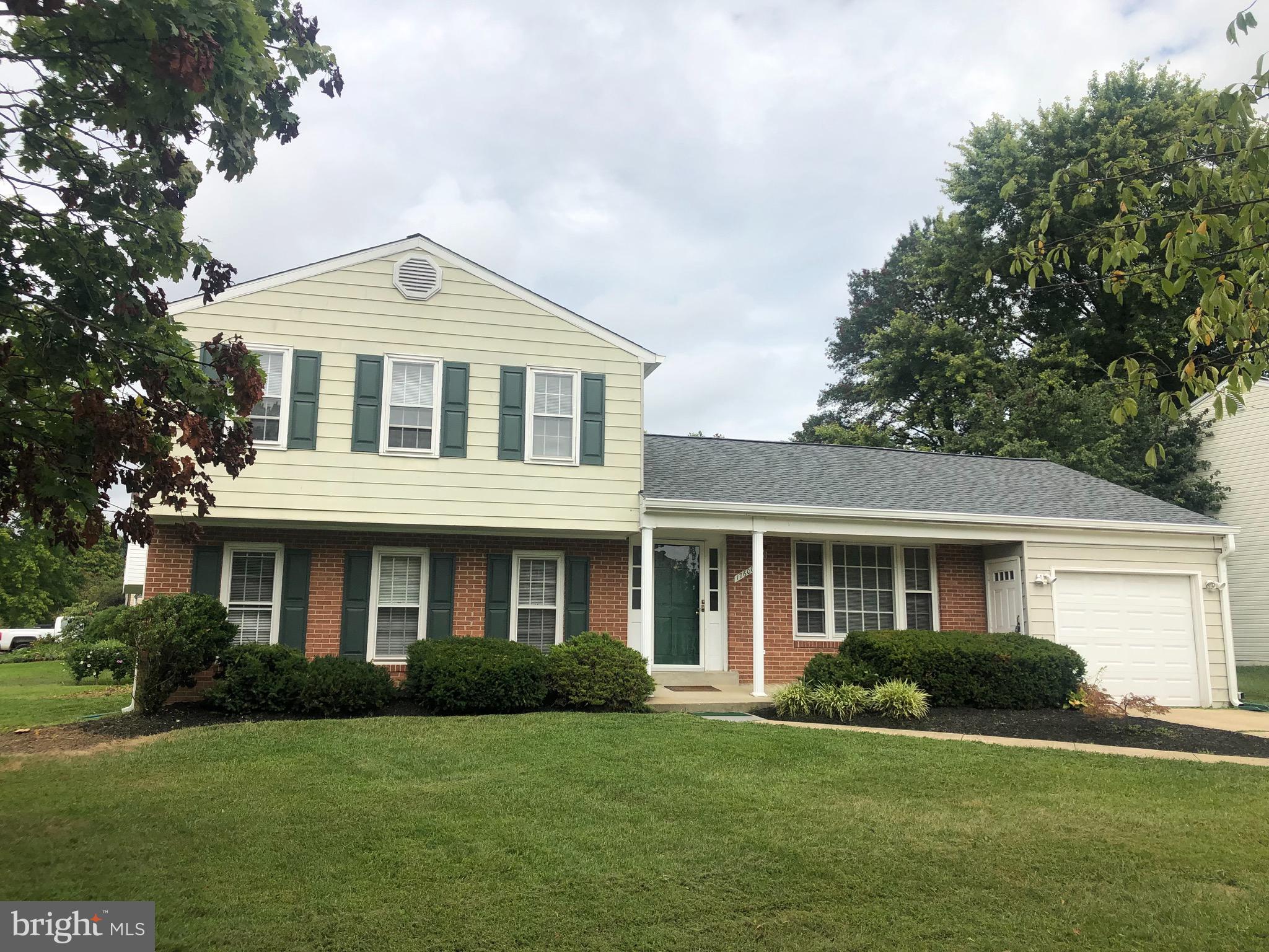 17600 Shamrock Drive Olney, MD 20832 - Photo 1 of 11 a front view of a house with a garden