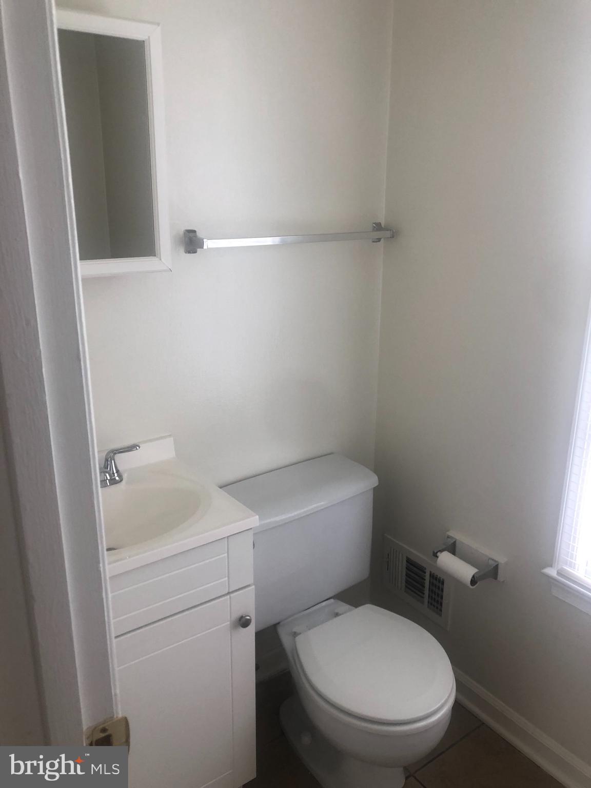 17600 Shamrock Drive Olney, MD 20832 - Photo 10 of 11 a white toilet sitting next to a bathroom sink