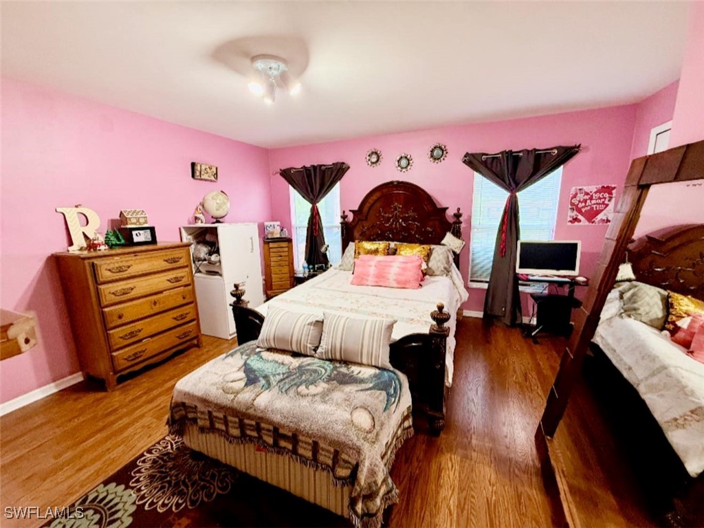 29 Alabama Road North Lehigh Acres, FL 33936 - Photo 11 of 24 a bedroom with a bed and wooden floor