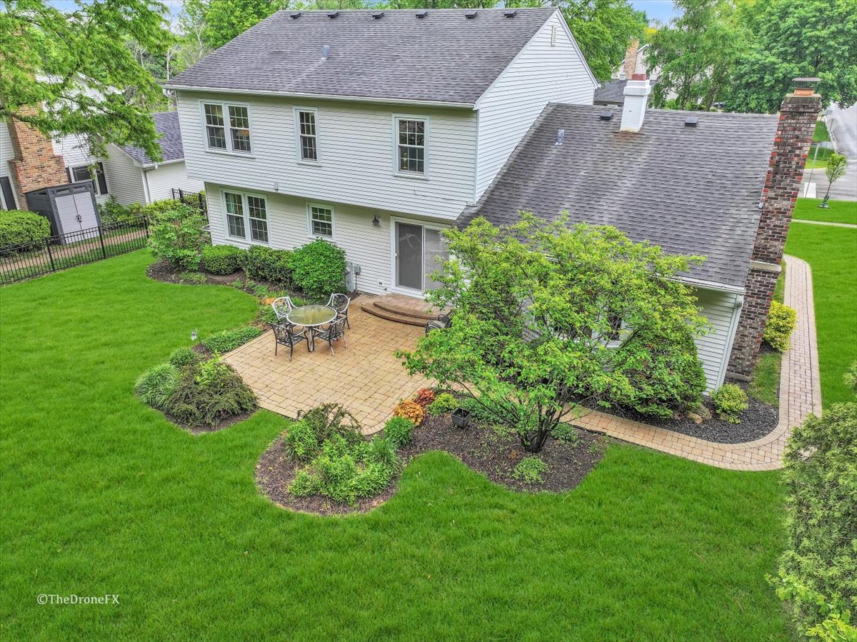 659 Brighton Drive Wheaton, IL 60189 - Photo 2 of 25 a view of a house with a backyard and a garden