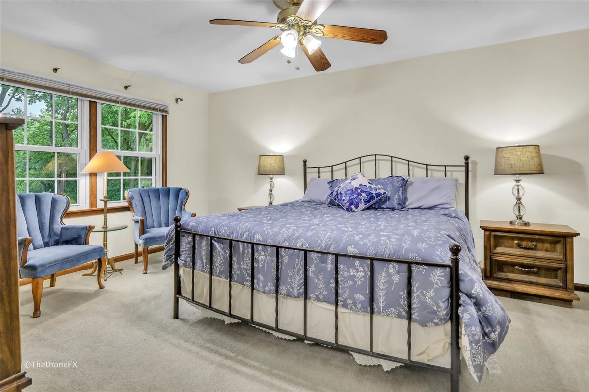 659 Brighton Drive Wheaton, IL 60189 - Photo 23 of 25 a bedroom with a bed a couch and a chandelier