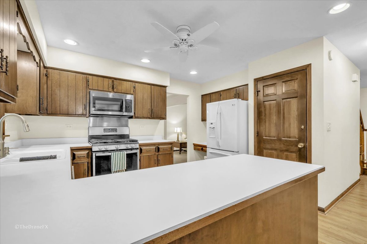 659 Brighton Drive Wheaton, IL 60189 - Photo 8 of 25 a kitchen with stainless steel appliances a stove sink refrigerator and cabinets