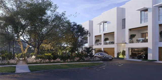 a front view of a house with a garden and yard