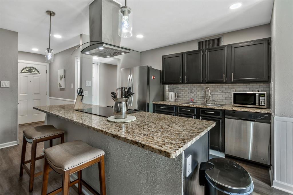5652 Phelps Street The Colony, TX 75056 - Photo 14 of 29 a kitchen with a sink a stove a refrigerator and cabinets