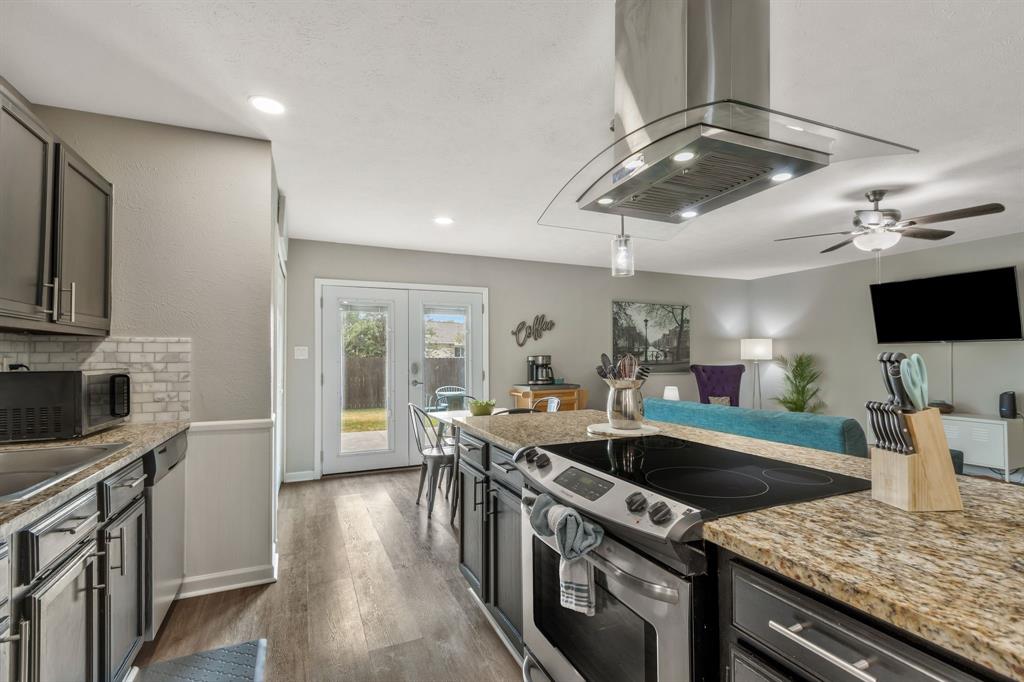 5652 Phelps Street The Colony, TX 75056 - Photo 16 of 29 a kitchen with stainless steel appliances granite countertop a sink stove and refrigerator