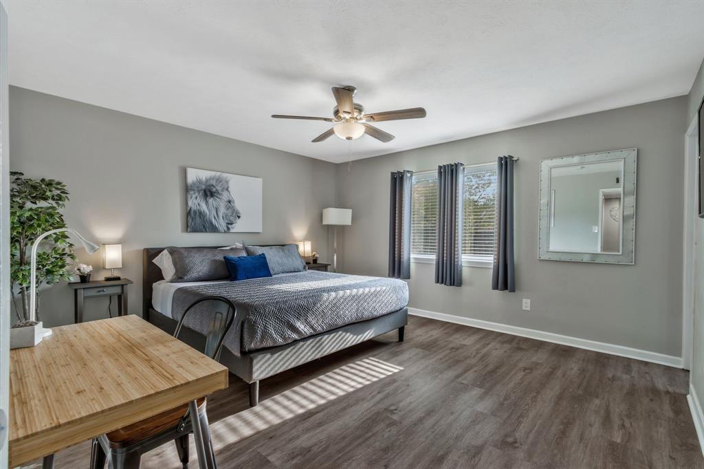 5652 Phelps Street The Colony, TX 75056 - Photo 18 of 29 a bedroom with a bed and a chandelier